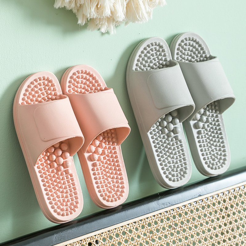 2 pairs of massage plastic slippers with pink and green color.