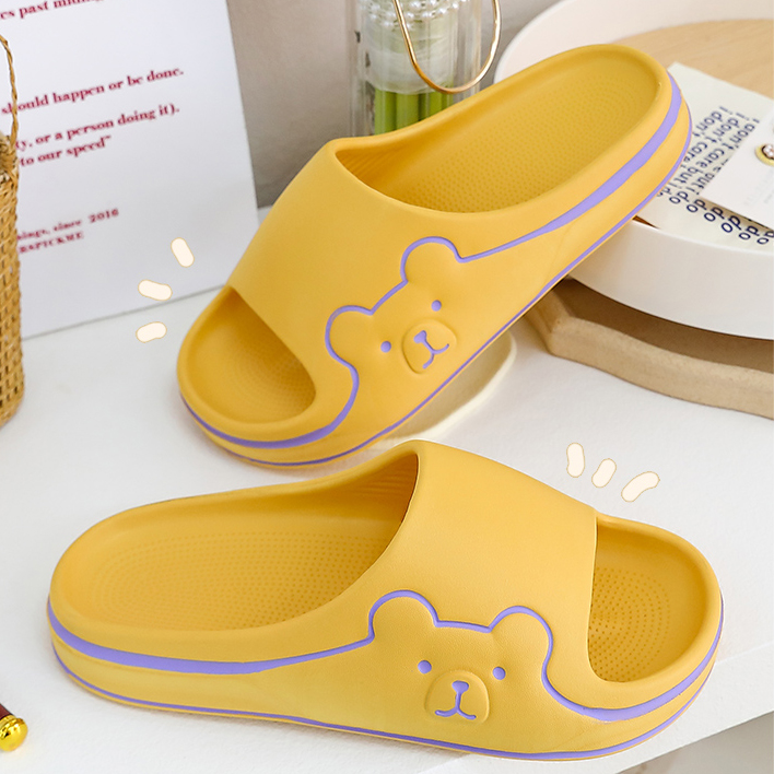 A pair of cartoon bear yellow slipper.