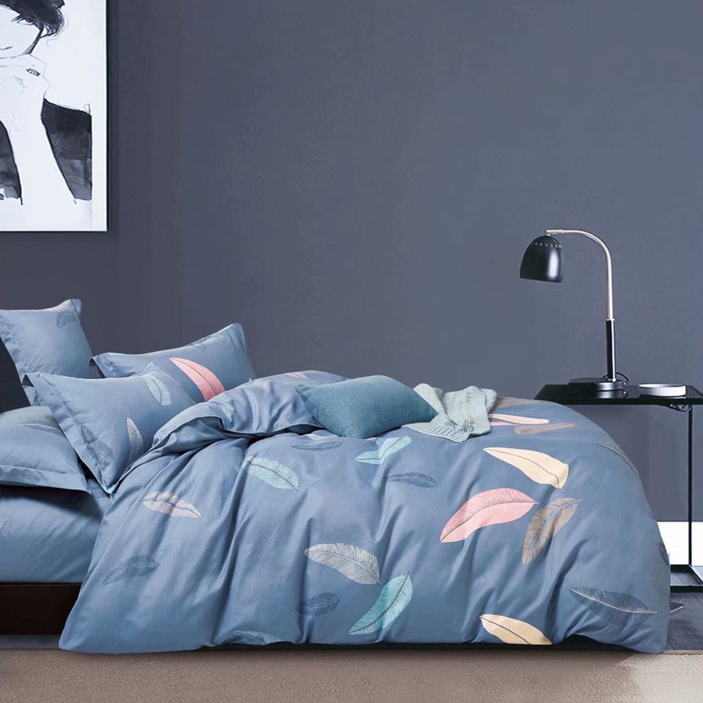 A set of leaf pattern blue bedding sheet displayed in the bedroom. There is a pillow on the bed.