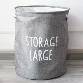 A grey laundry basket with text "Storage large."