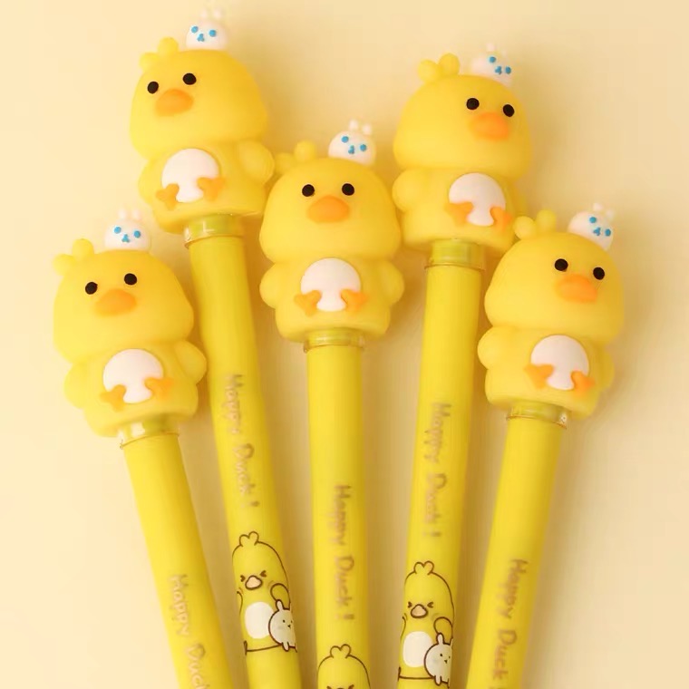 A group of yellow duck shaped pens on a yellow background.