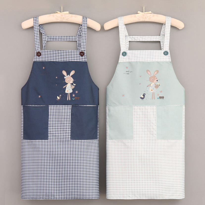 2 Aprons is hanged on. The blue one is on the left, and the green one is on the right. Both of them are having the same cartoon rabbit pattern.