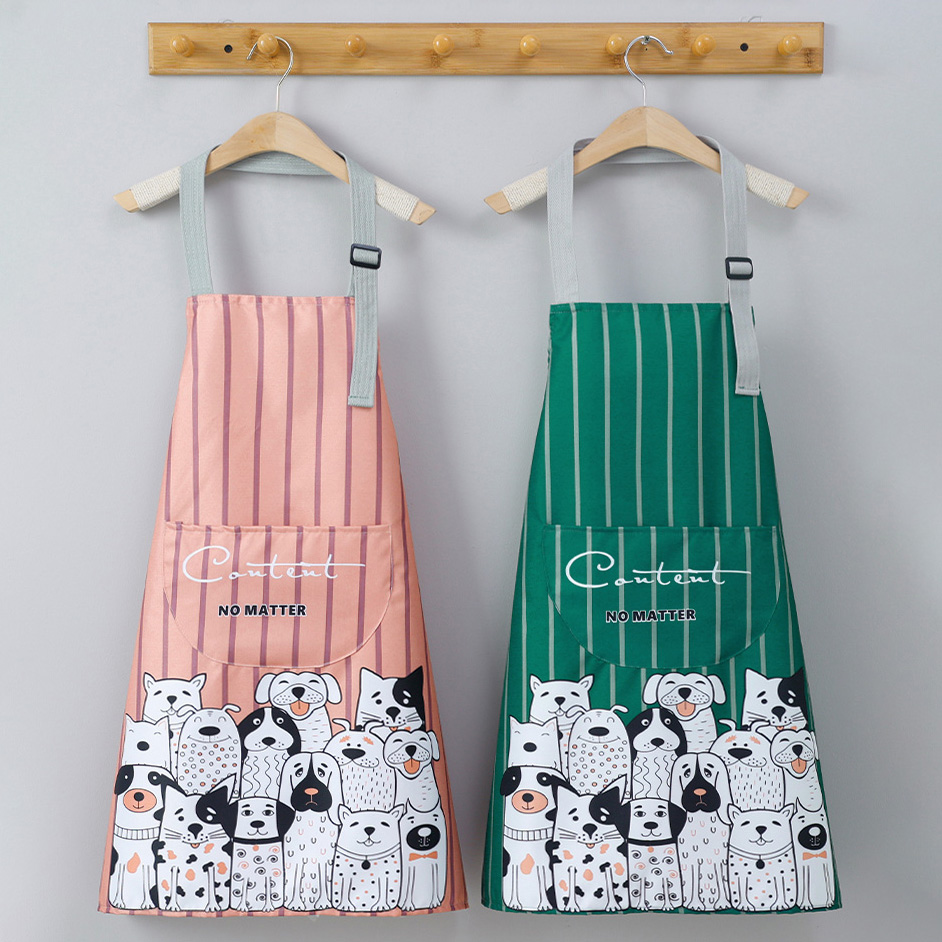 2 Aprons is hanged on the wooden hanger. The pink one is on the left, and the green one is on the right. Both of them are having the same black and white cats and dogs pattern.