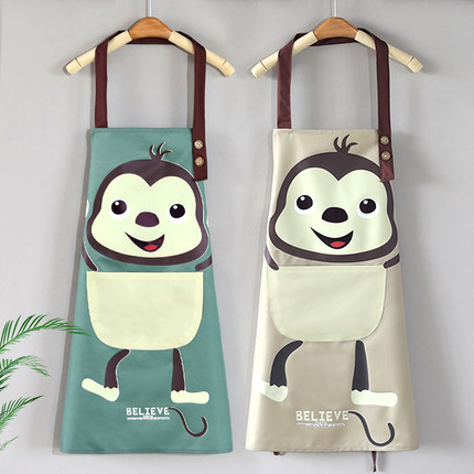 2 Aprons is hanged on. The green one is on the left, and the yellow one is on the right. Both of them are having the same cartoon monkey pattern.