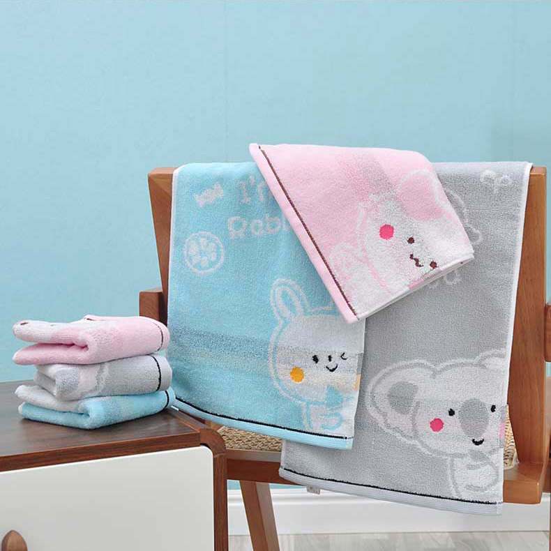 A set of towels with a cat, rebbit and koala on them. They have pink, blue and grey in color.