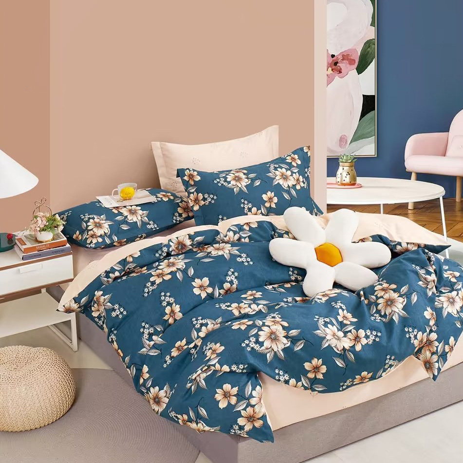 A set of white flower pattern bedding sheet displayed in the bedroom. There is a flower shaped white cushion on the bed. This is an image of showing one's better living product.