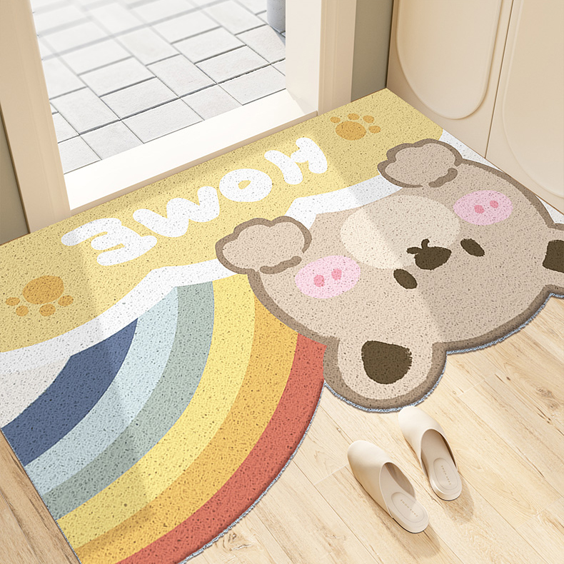 A carpet with pattern of a cartoon bear with colorful rainbow on the floor. With the text "Home". This is an image of showing one's better living product.