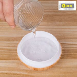 Adding water to a humidifier.